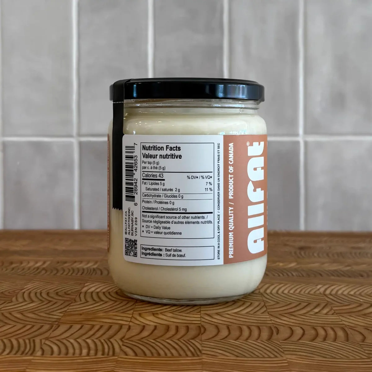 AllFAT grass-fed beef tallow in a jar, showcasing the golden, solid cooking fat made from 100% grass-finished beef.