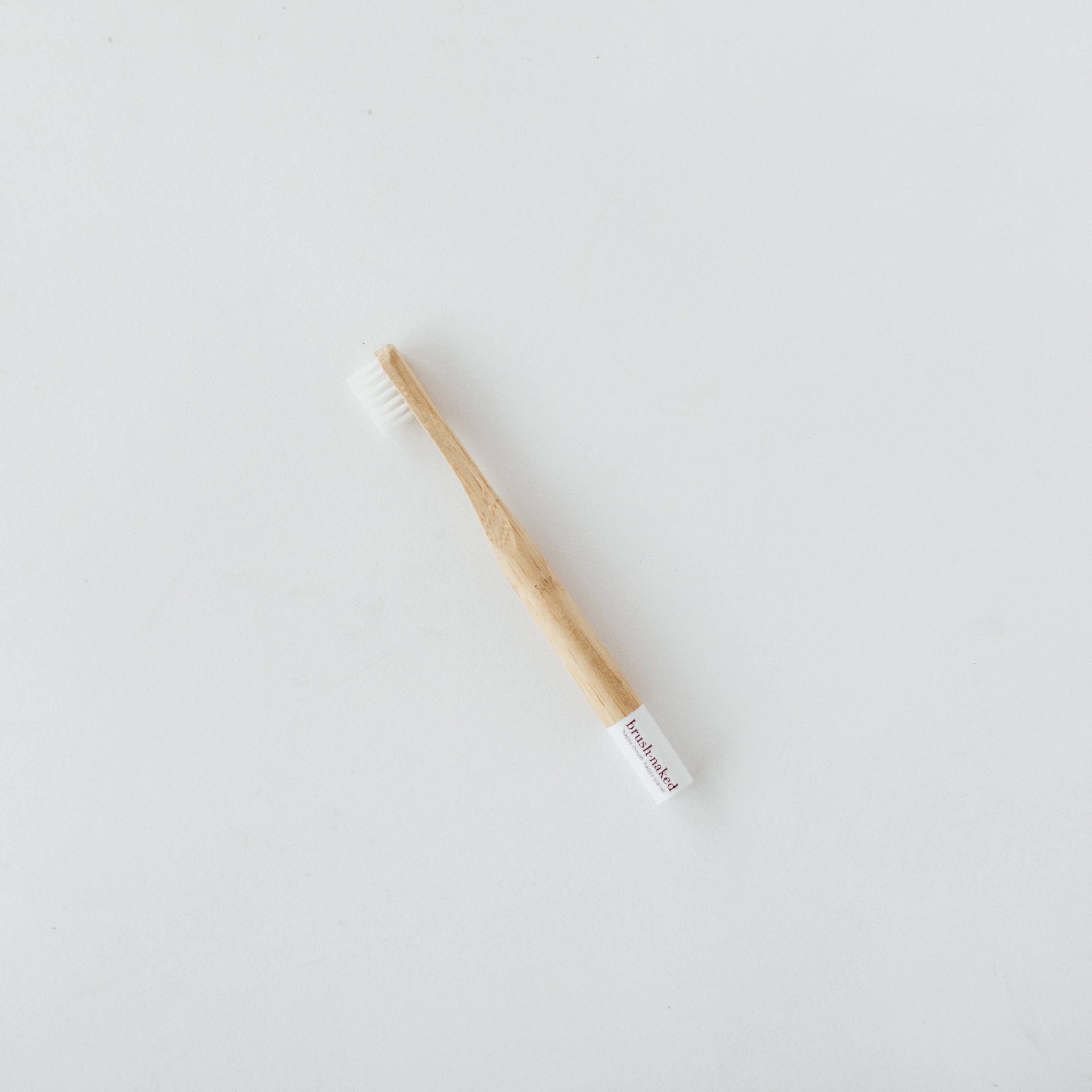 Kids' soft nylon toothbrush by Brush Naked with colorful handles and gentle bristles for effective dental cleaning.
