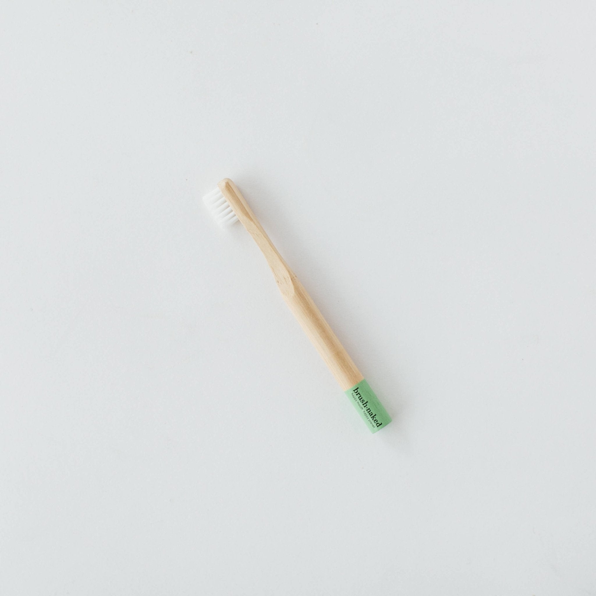 Kids' soft nylon toothbrush from Brush Naked with colorful bristles designed for gentle cleaning and oral care.